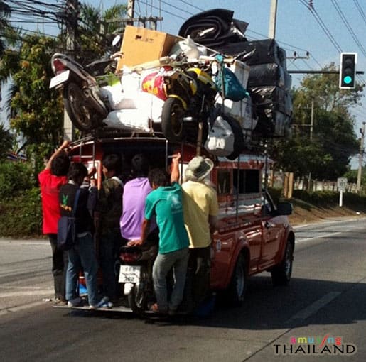 best rated cross country moving companies funny picture in Thailand of a very overloaded pickup truck with people hanging onto the back Middle Class Dad