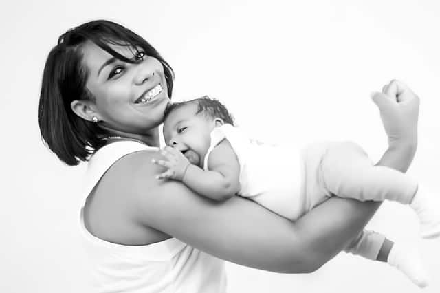 effective parenting tips Middle Class Dad black and white photo of a Mom and baby