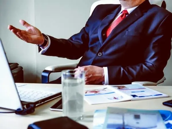 meeting ground rules for facilitators Middle Class Dad business man at a desk wearing a blue suit