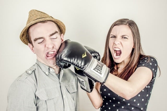 Gottman's Four Horsemen Middle Class Dad woman with boxing gloves on punching a guy in a hat