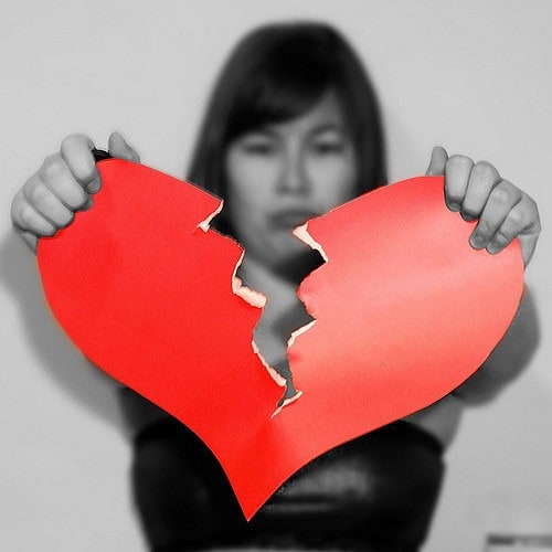 woman in black and white tearing a red paper heart in halfMiddle Class Dad top reasons for divorce statistics