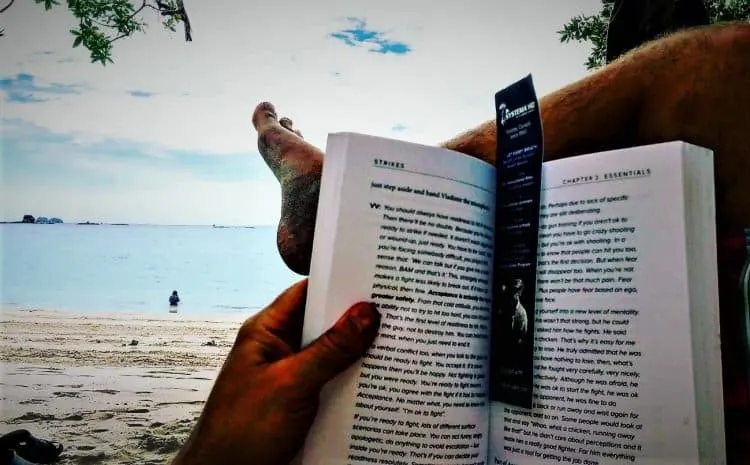 steps to plan a vacation Middle Class Dad Jeff Campbell reading the Systema Strikes book on the beach in Costa Rica