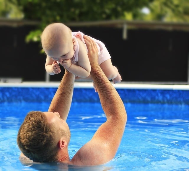 qualities of a good father dad and baby in pool middle class dad