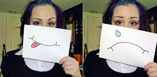 repetition compulsion girl in 2 poses one with a happy face and one with a sad face drawn on signs Middle Class Dad