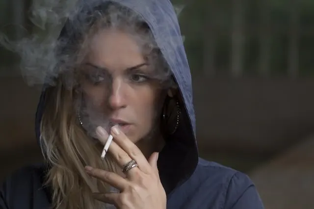 young woman in a hoodie smoking Middle Class Dad repetition compulsion