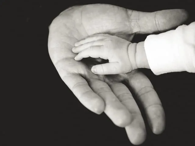 great Father's Day Quotes black and white photo of a tiny hand resting in an adult hand Middle Class Dad