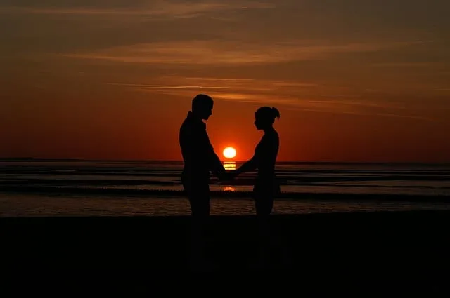 Middle Class Dad can marriage counseling help couple at sunset holding hands