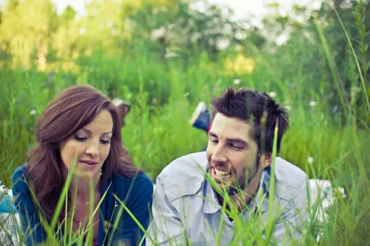 empathic listening skills happy couple sitting in a grassy field Middle Class Dad
