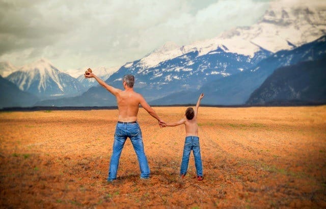 anti dad bod workout shirtless dad and son in a field with mountains in the background Middle Class Dad