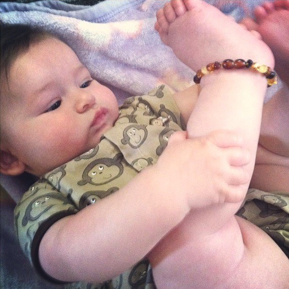 amber teething necklace on ankle