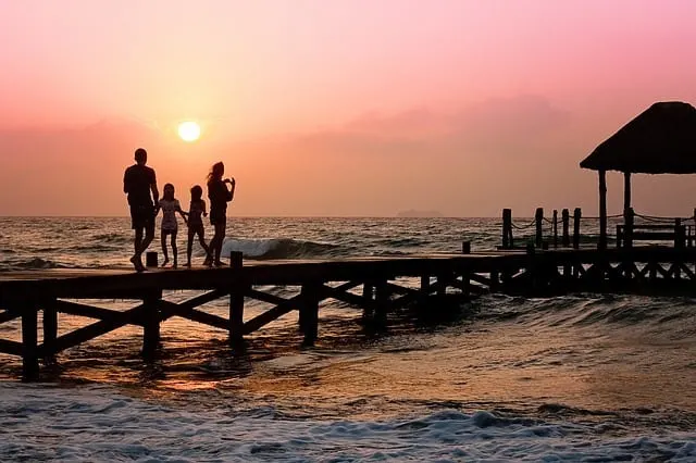 life insurance tips and advice Middle Class Dad family on a pier overlooking the ocean at sunset