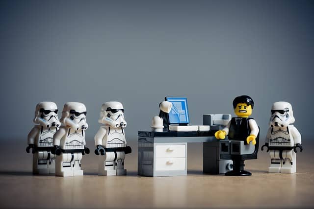 micromanagement examples Middle Class Dad Lego Stormtroopers surrounding a manager at a desk