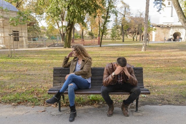 signs your wife wants a divorce couple on a park bench guy has his head in his hands and the woman is looking away Middle Class Dad