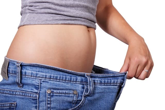 flat belly after 40 a think woman with her shirt partially lifted up in jeans that are several sizes too large Middle Class Dad