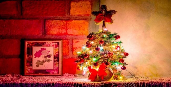how to hang Christmas lights on brick walls Small Christmas tree on shelf in front of brick wall Middle Class Dad