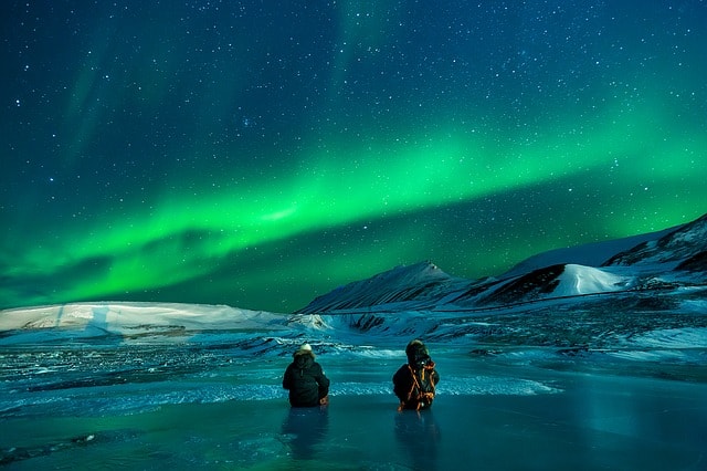 what is trekking all about? Middle Class Dad 2 people in Alaska staring at the Northern Lights